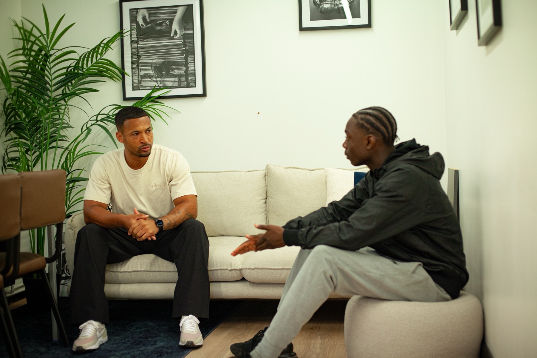 A mentor and a young person talking on a sofa