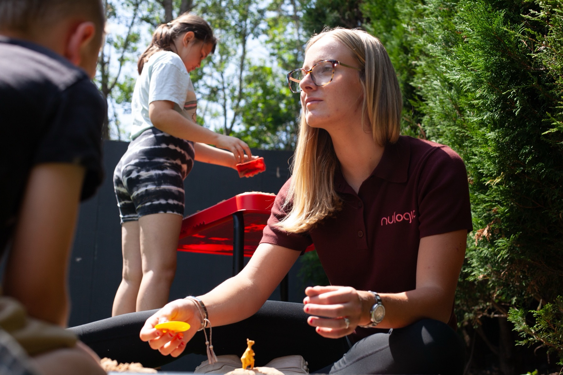 A member of staff and a young pupil working together at a table